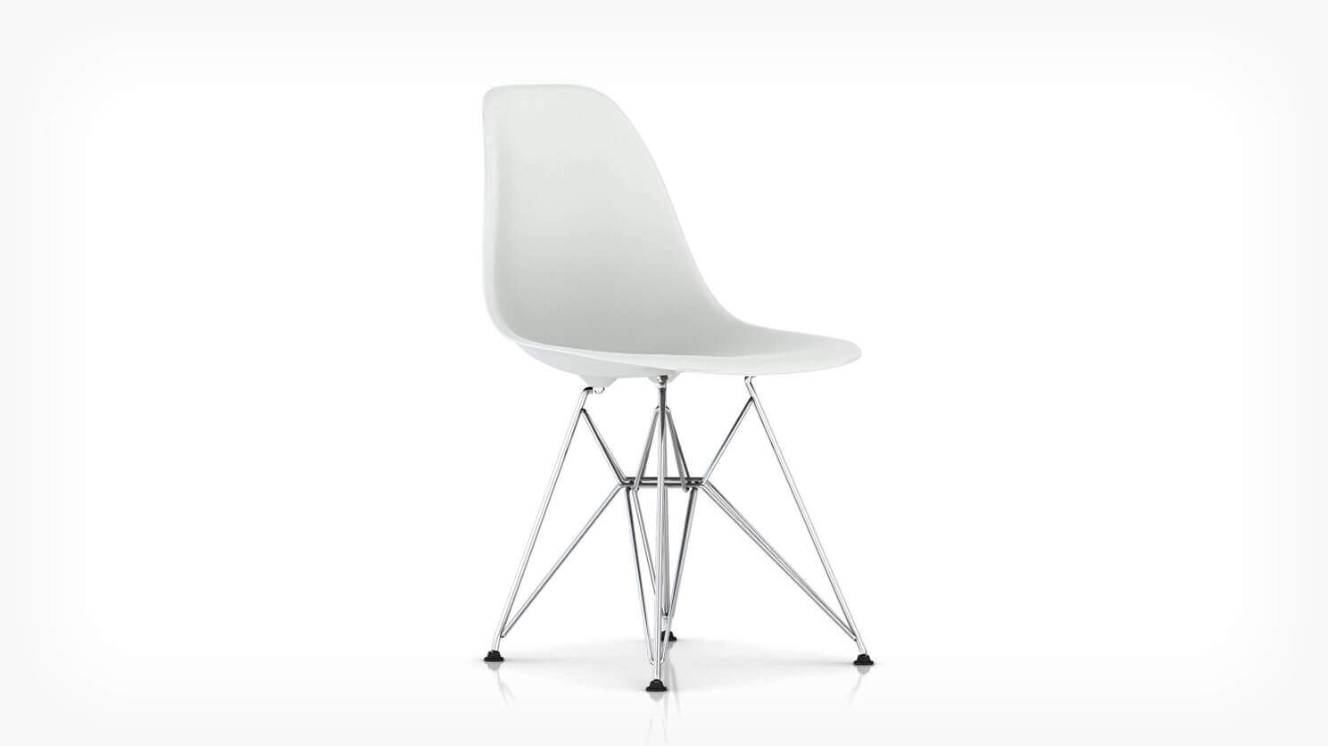 Front angle view of white Eames molded plastic chair with wire base