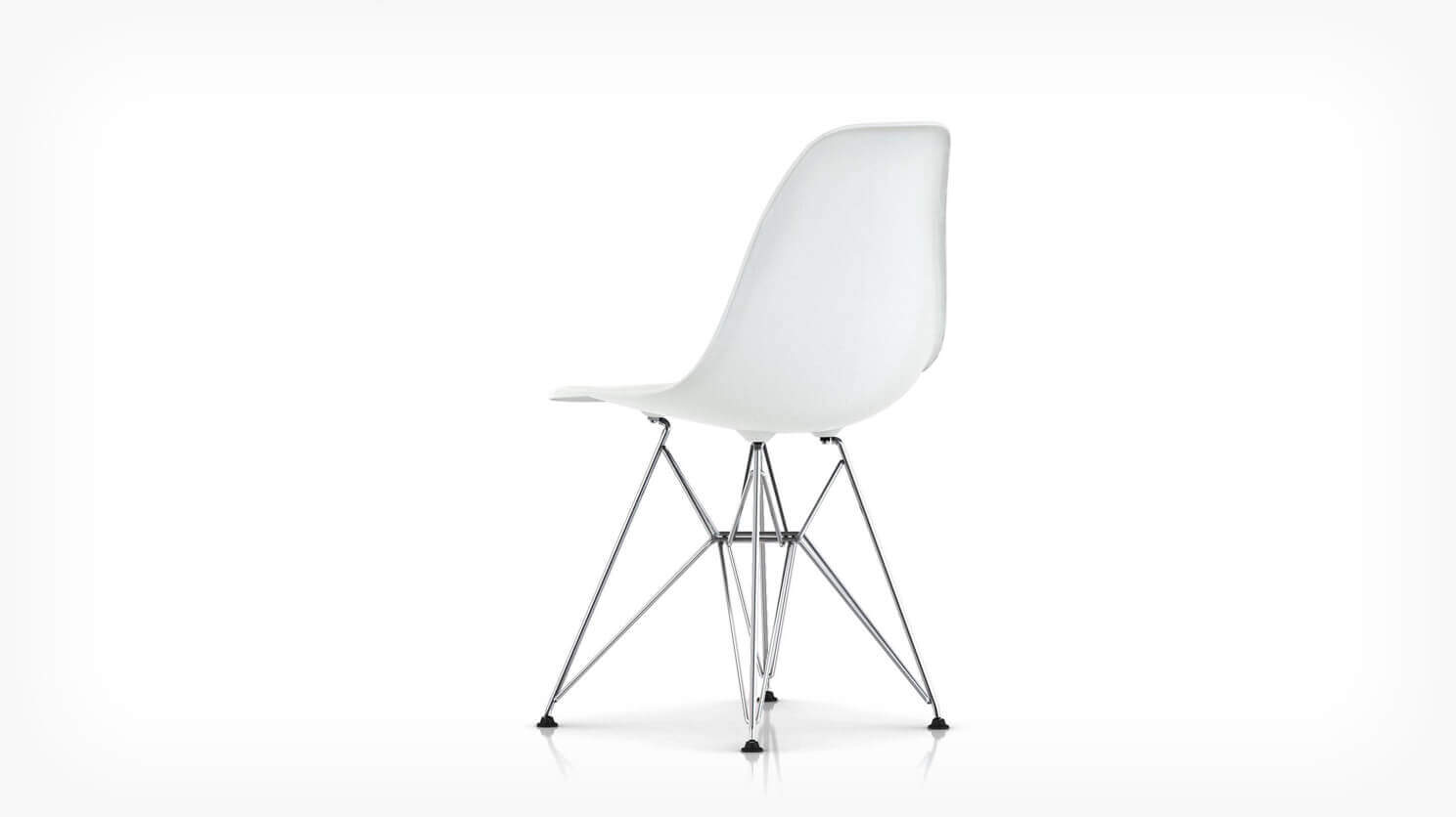 Back angle view of white Eames molded plastic chair with wire base