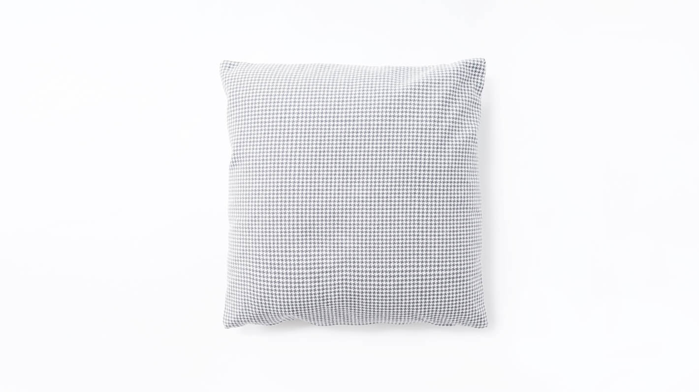 Front view of square pillow upholstered in grey houndstooth fabric