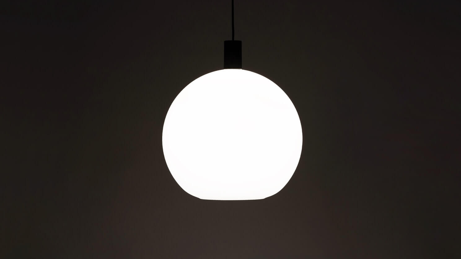 The Wellington large glass shade modern pendant lamp in black with light on