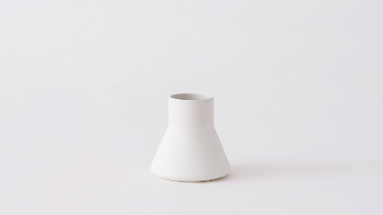 Small white ceramic vase front view