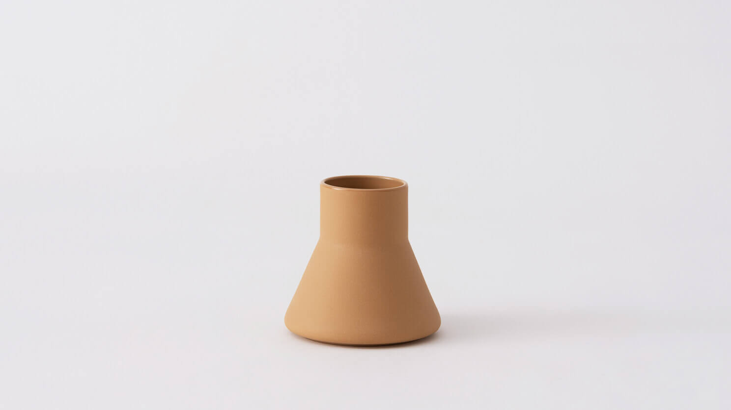 Front view of small beige ceramic vase