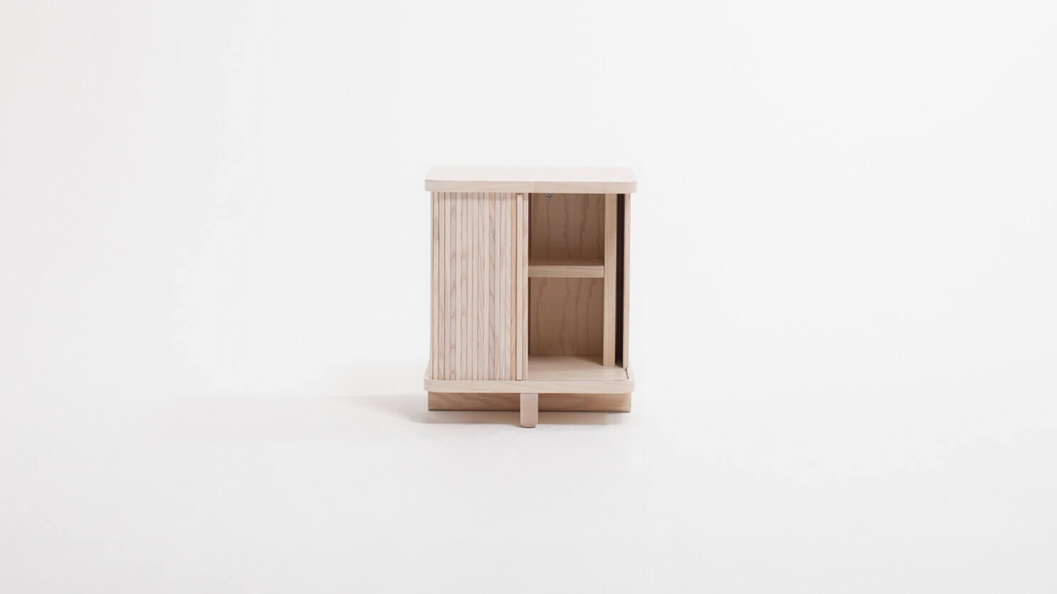 Front view of the Tambour modern end table in ash with drawer half open