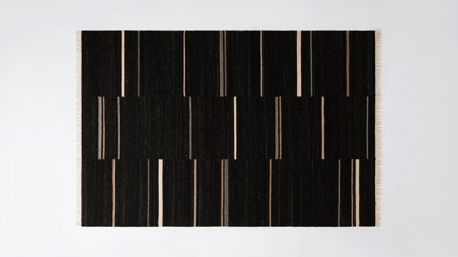 Top view of black area rug with grey and brown stripes