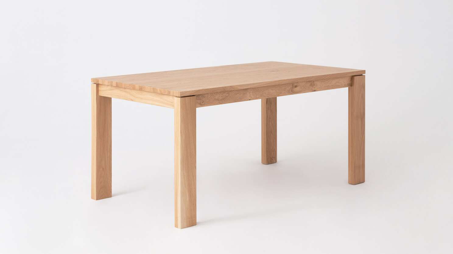 Angled view of the small Bon solid wood dining table in oak