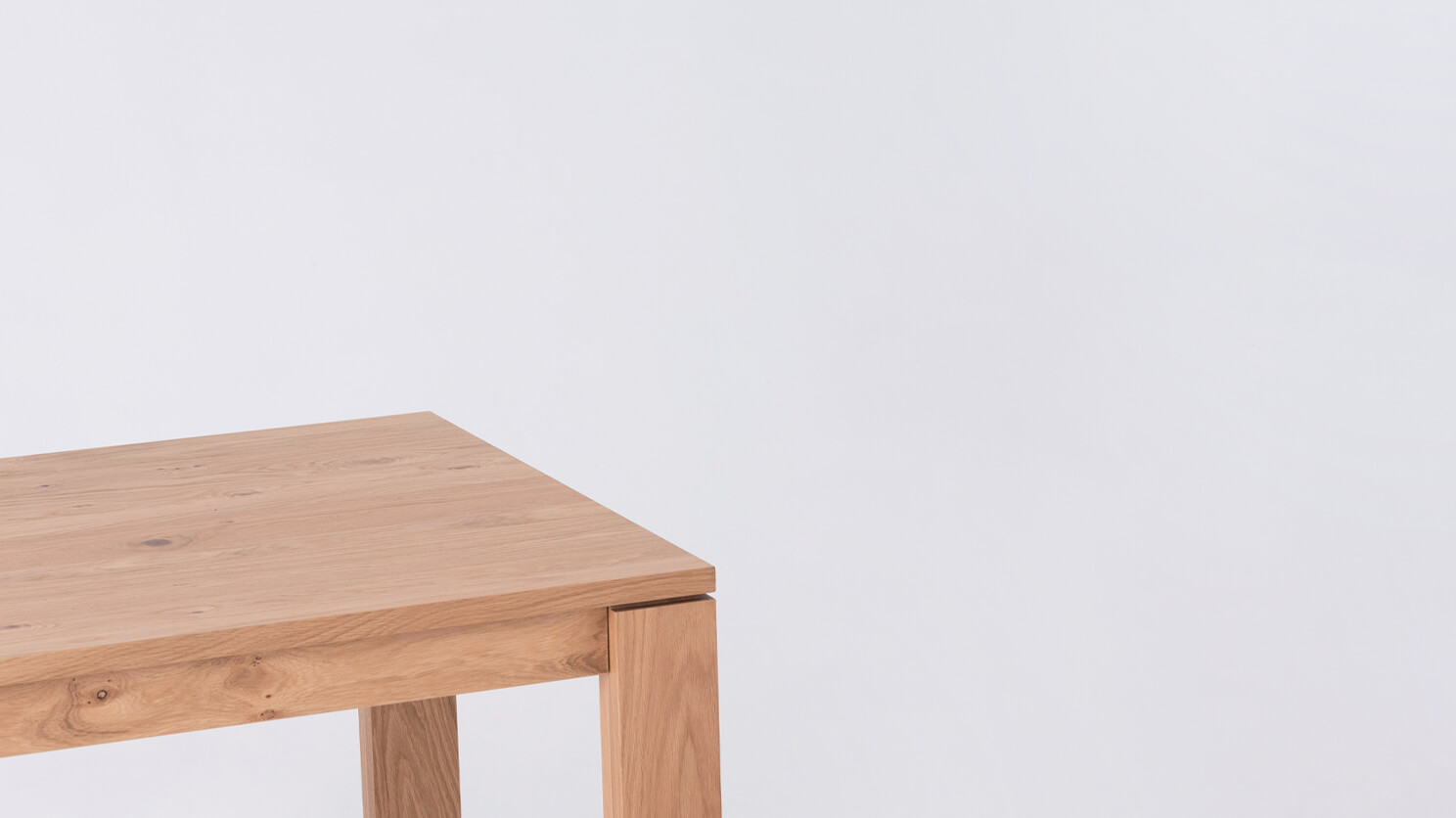 Detail view of the Bon solid wood dining table in oak