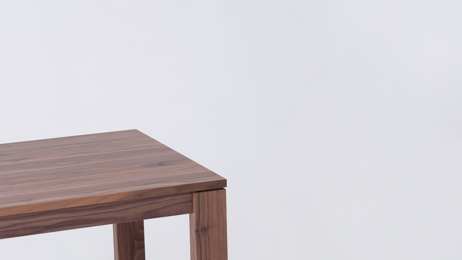 Detail view of the Bon solid wood dining table in walnut