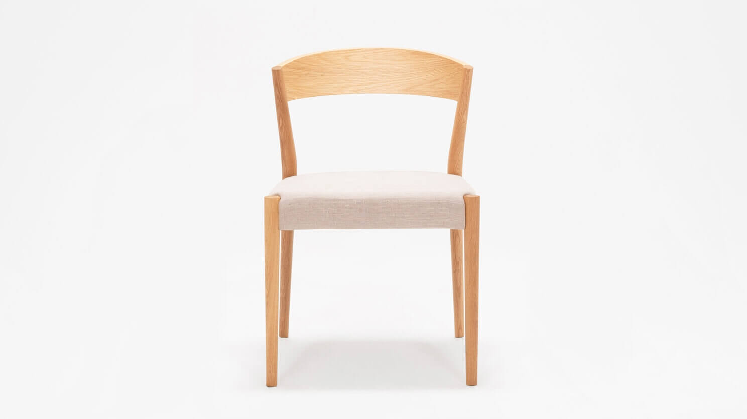 Front view of the Wren upholstered dining chair in oak with wood back