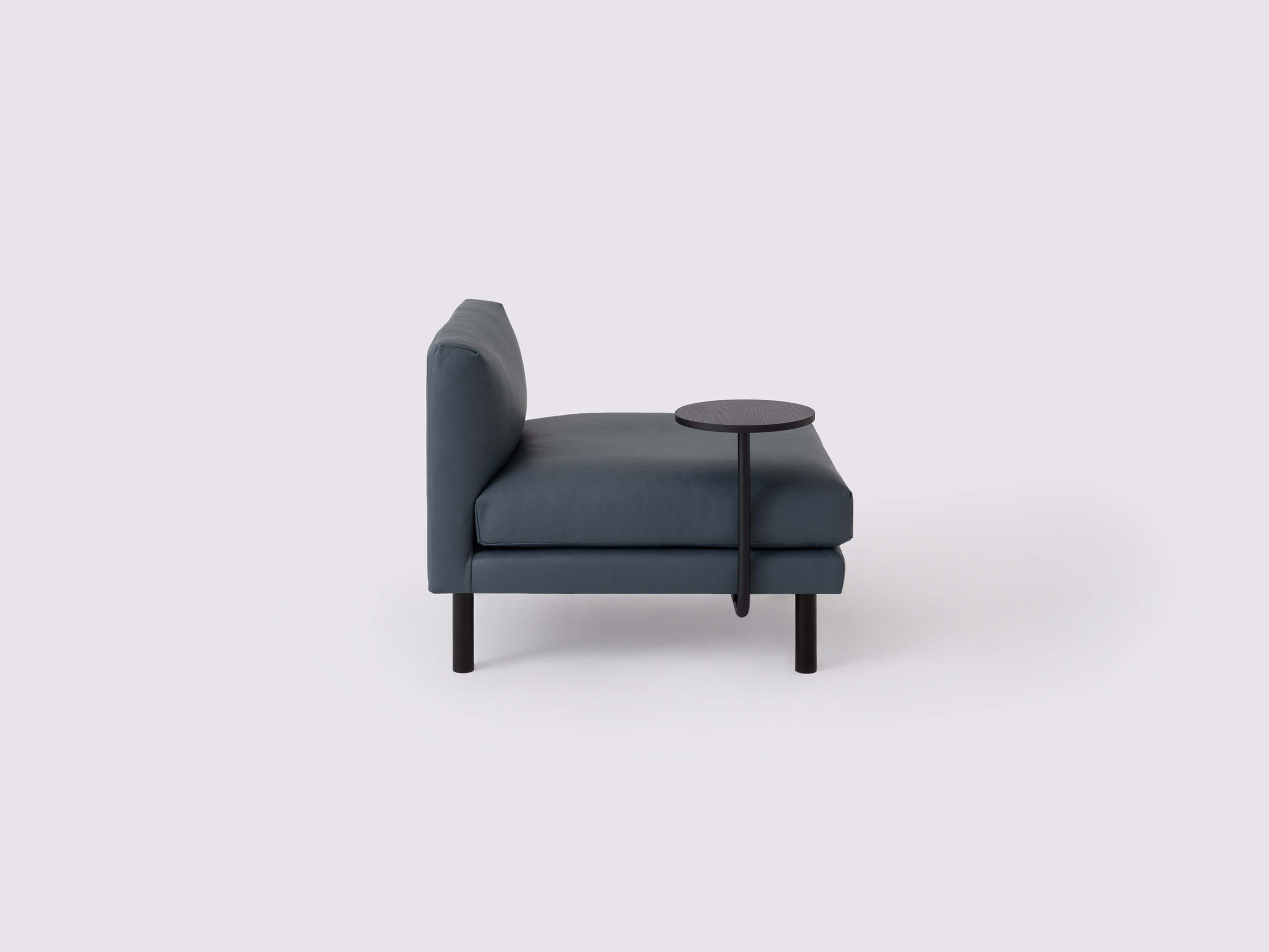 Side view of the round Replay floating side table in black oak