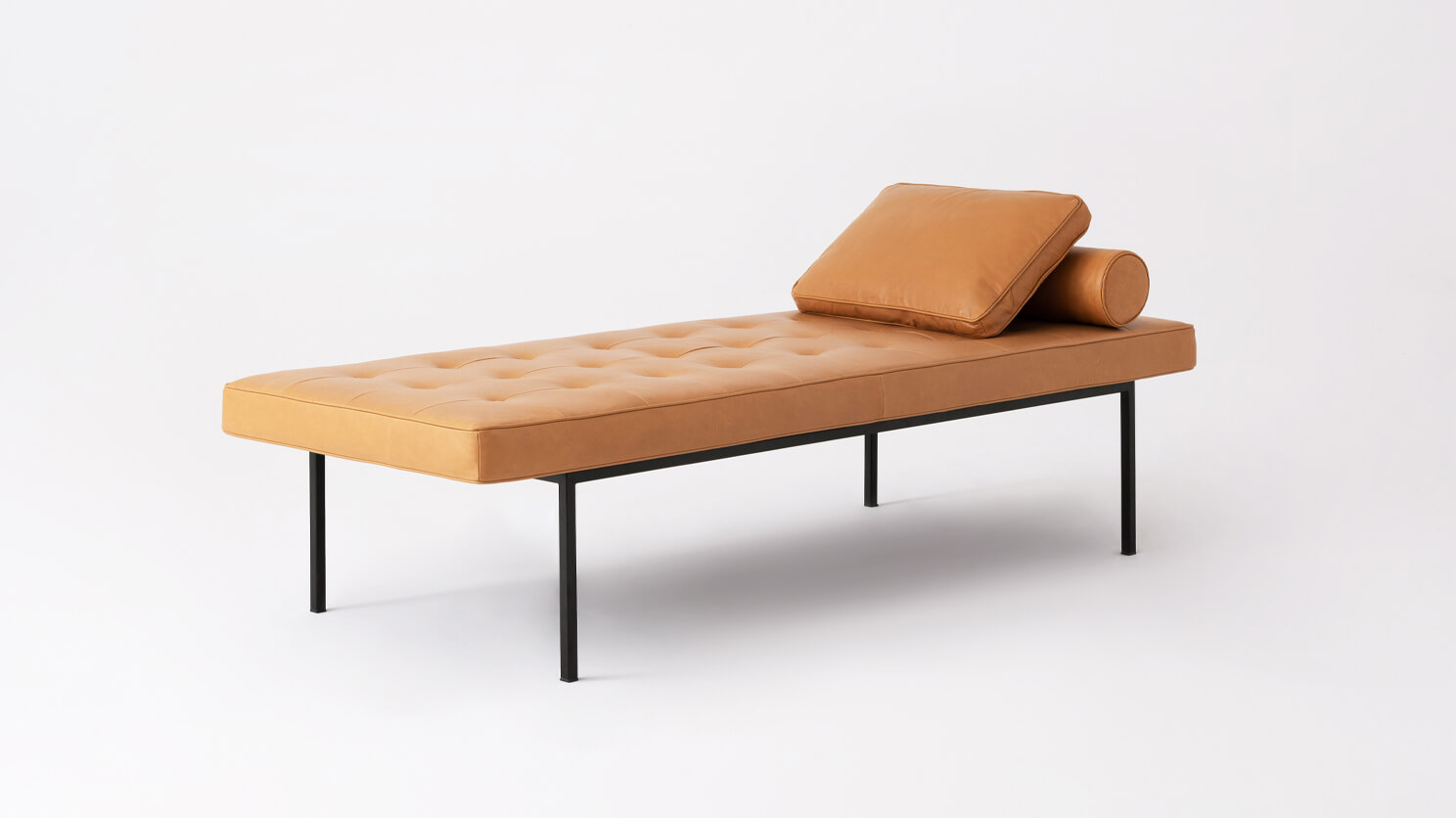 Angled view of the Bank upholstered dining bench in brown leather with cushions