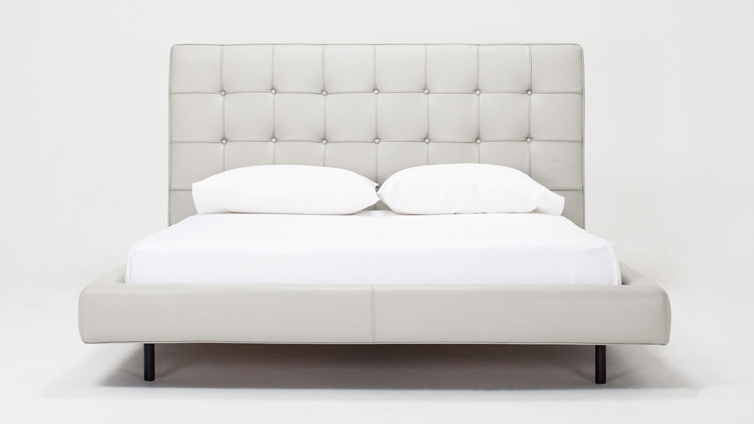 Front view of Winston, the mid century modern bed, in pale grey leather with a high headboard