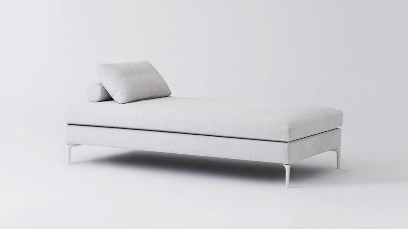 Angled view of the Eve chaise lounge sofa in grey fabric.