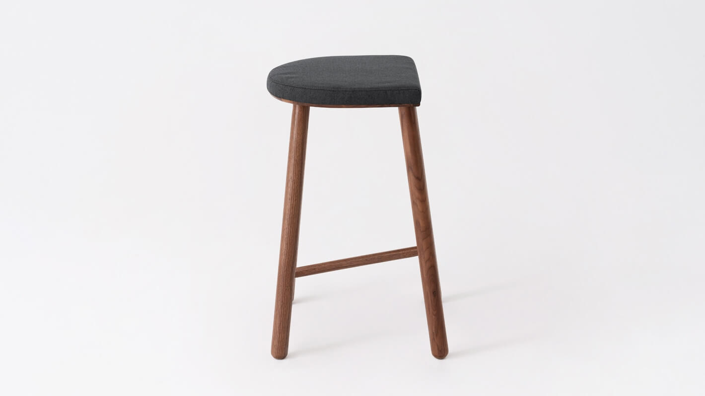 Side view of the Lima custom counter stool with black seat and walnut base