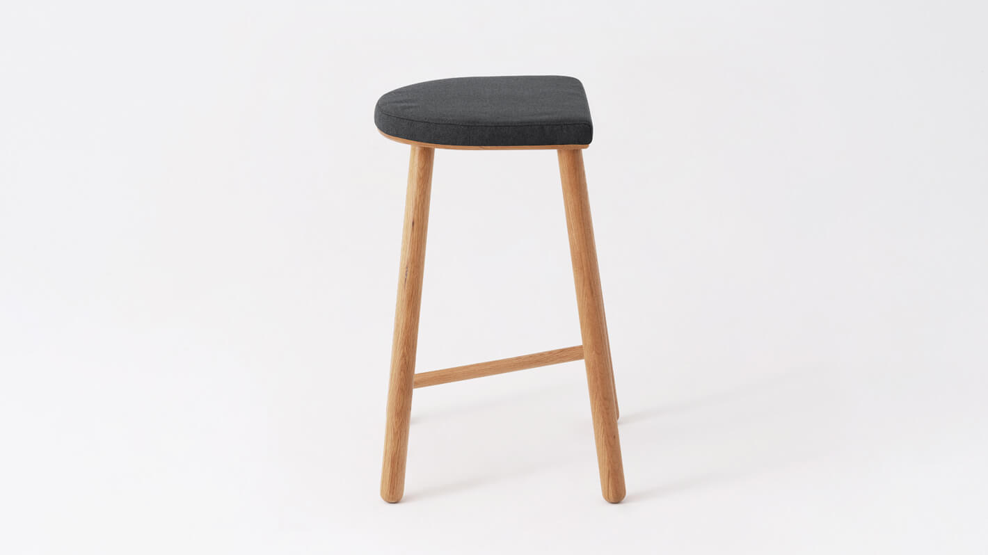 Side view of the Lima custom counter stool with black seat and oak base