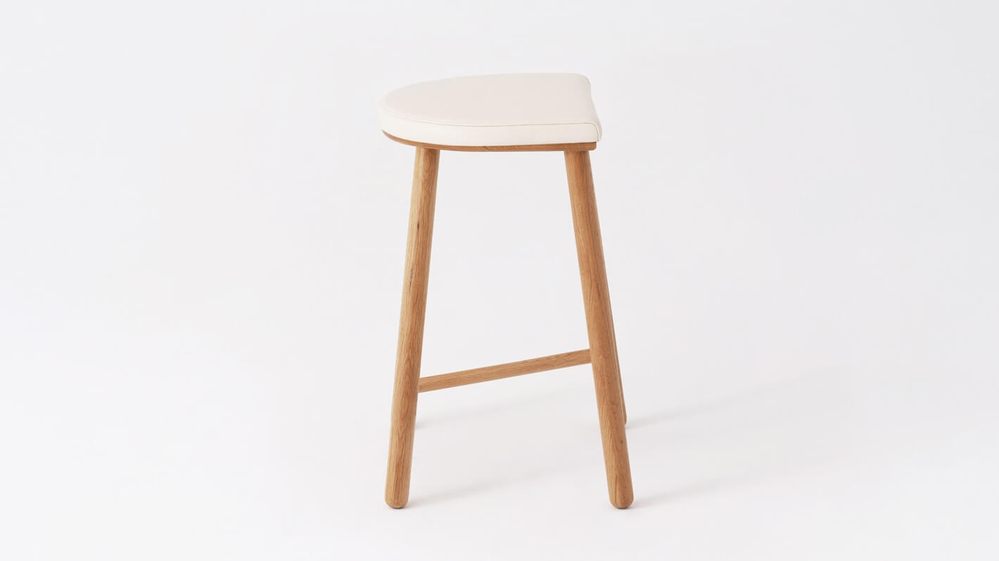 Side view of the Lima custom counter stool with white leather seat and oak base