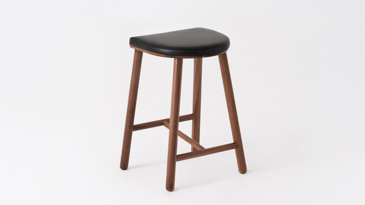 Back angled view of the Lima custom counter stool with black leather seat and walnut base