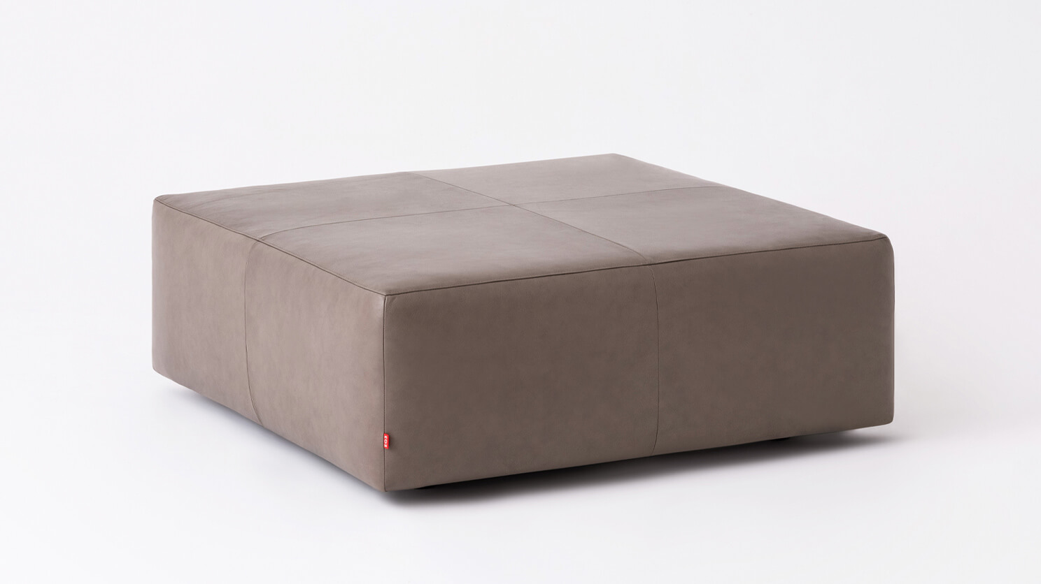 Angled view of the Morten mid century ottoman in grey leather