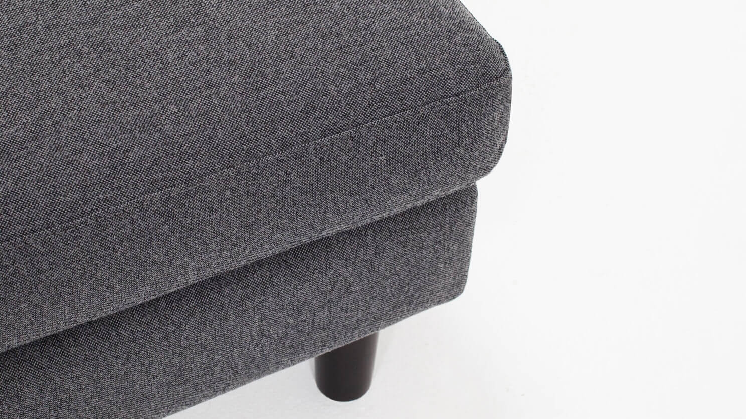 Detail view of the Oskar modern ottoman in grey fabric