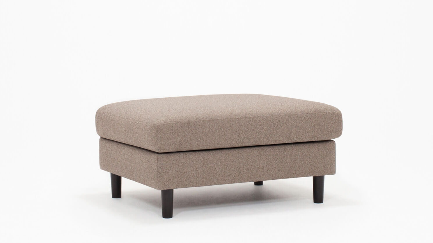 Angled view of the Oskar modern ottoman in beige fabric