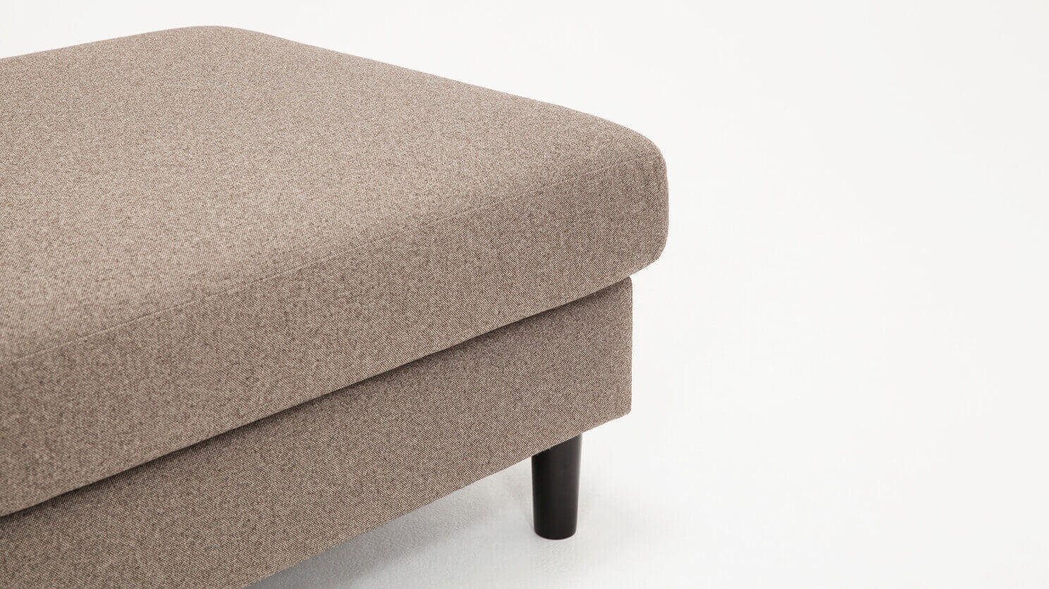 Detail view of the Oskar modern ottoman in beige fabric