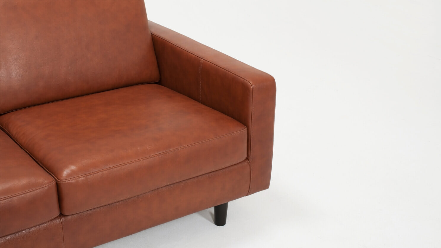 Detail view of the Oskar modern loveseat in brown leather