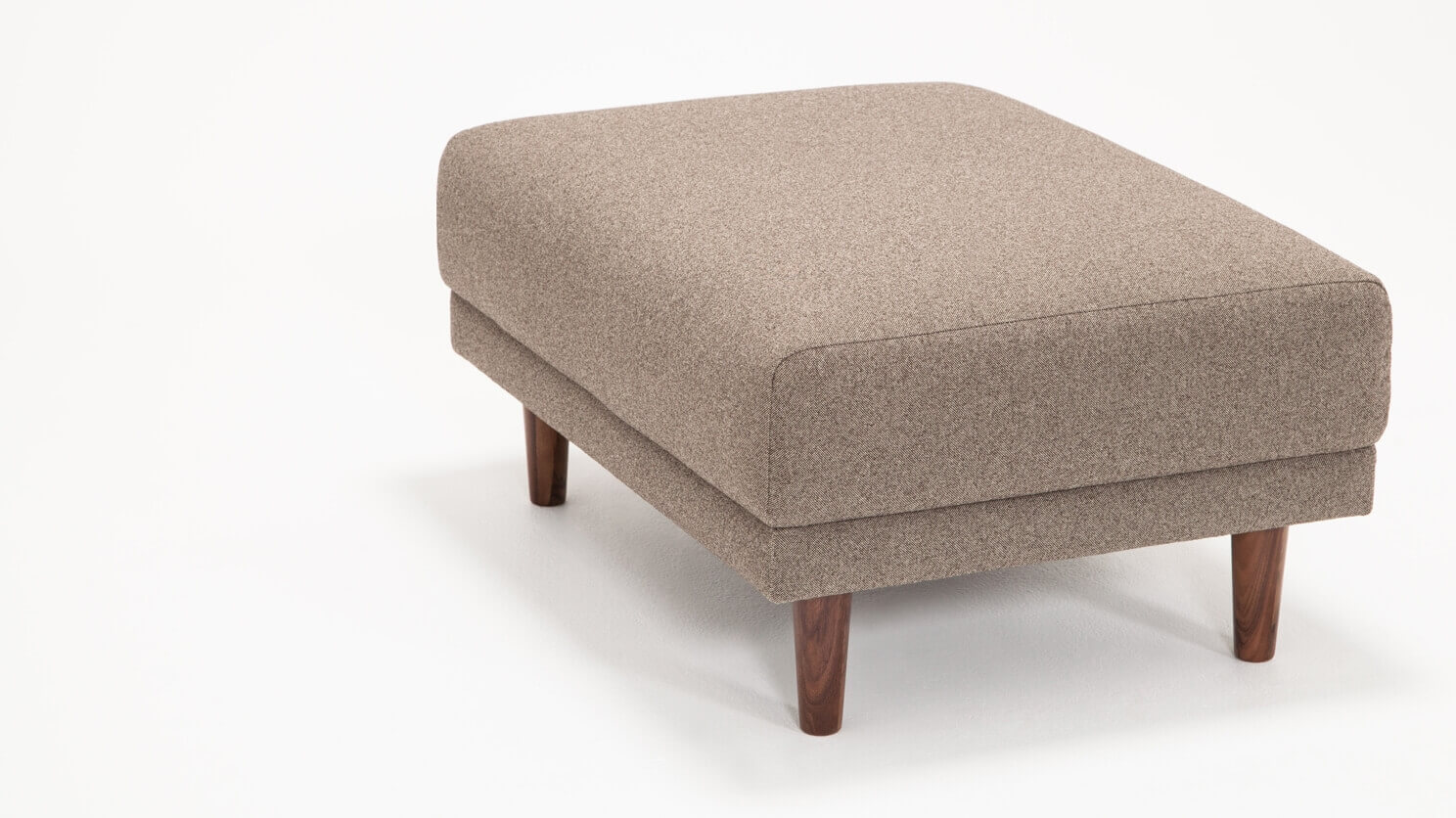 Corner view of the Remi modern ottoman in beige fabric