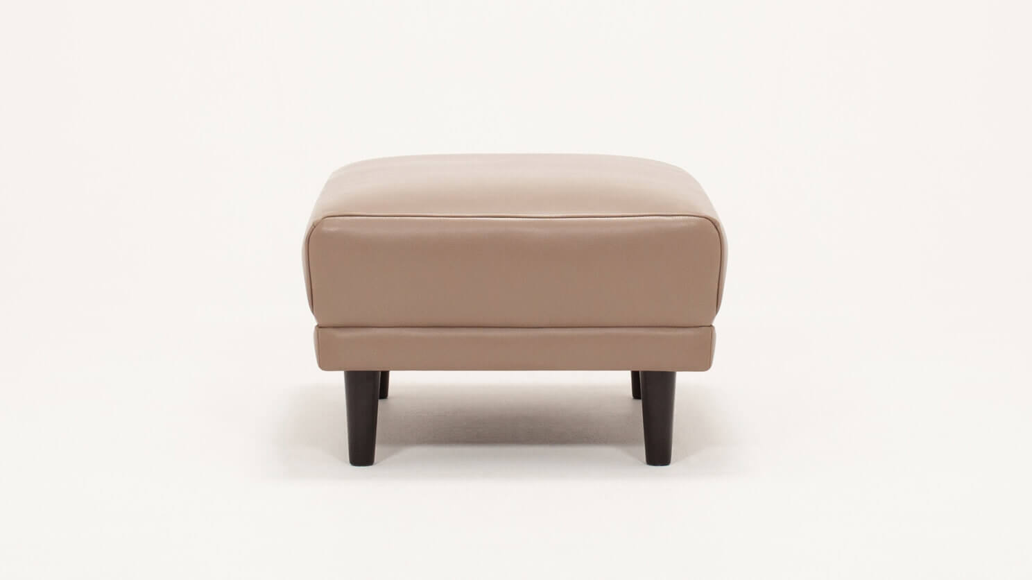 Side view of the Remi modern ottoman in beige leather