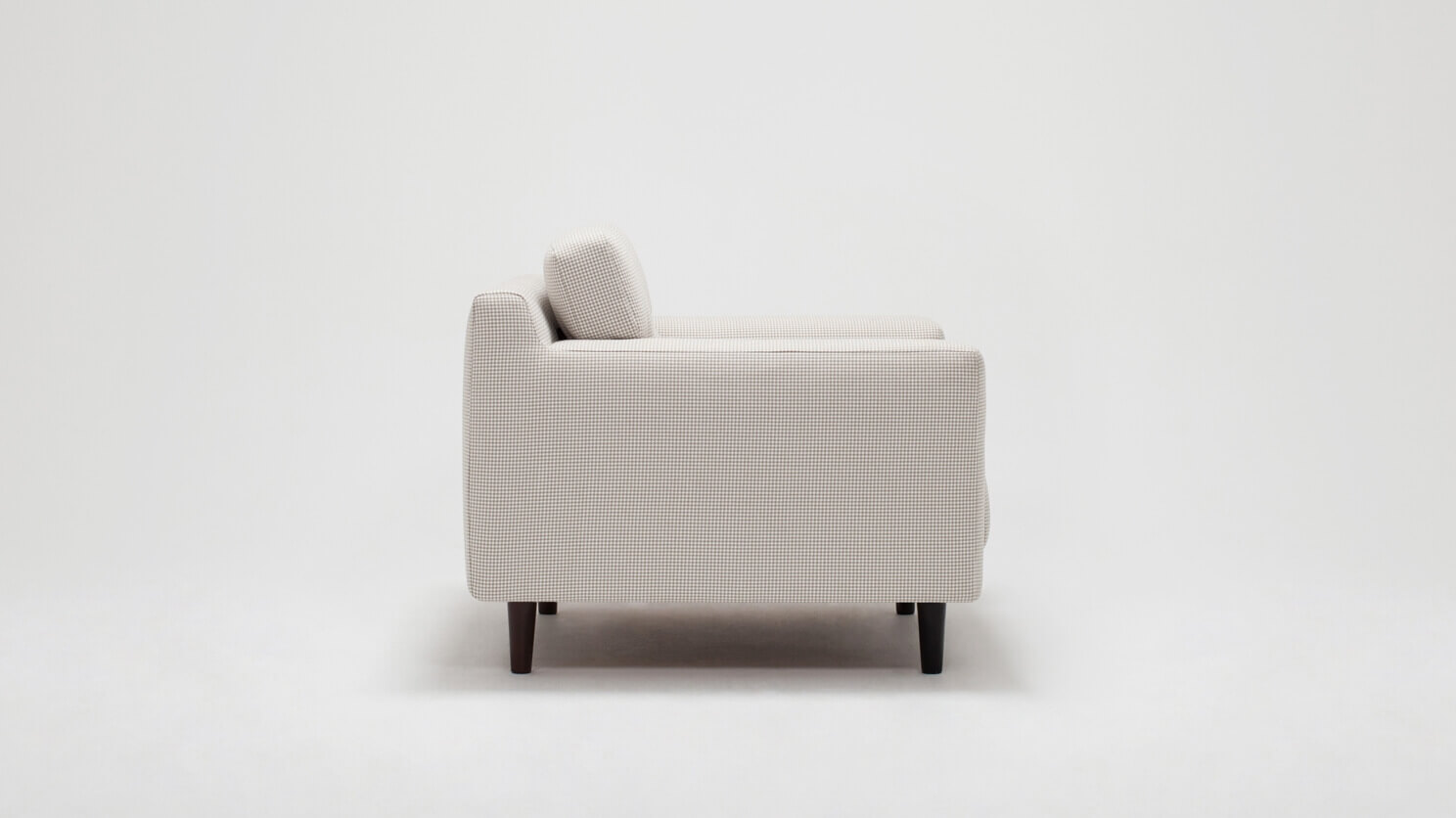 Side view of the Remi mid century modern lounge chair with buttons in white fabric