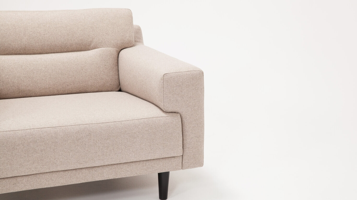 Detail view of the Remi mid century modern lounge chair with horizontal pull in beige fabric