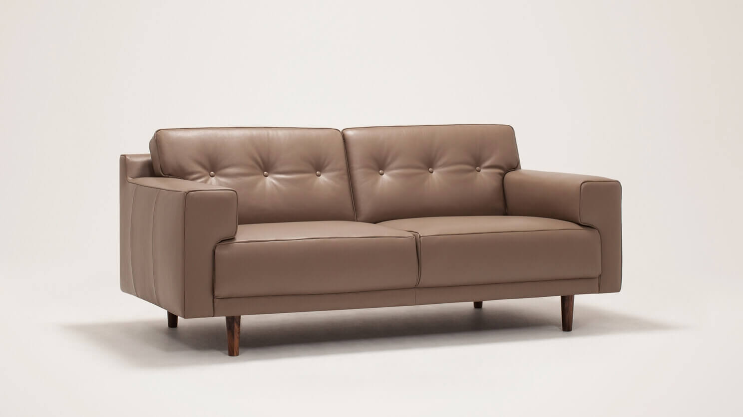 Angled view of the Remi modern loveseat with buttons in grey leather