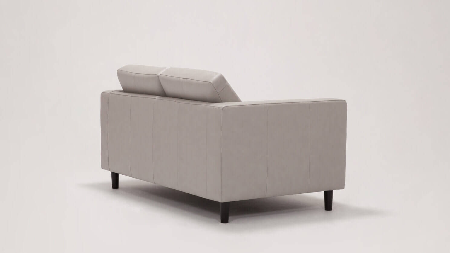 Angled back view of the Solo mid century modern loveseat in grey leather