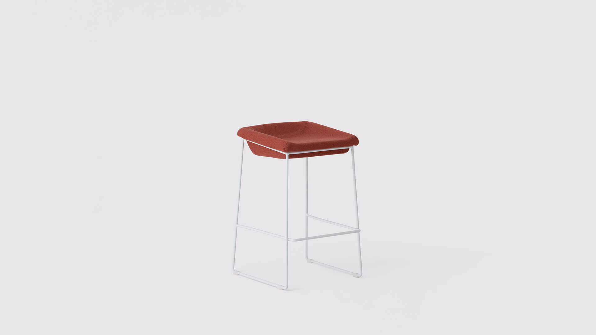 Angled view of the Mackenzie Custom counter or bar stool with orange seat and white base