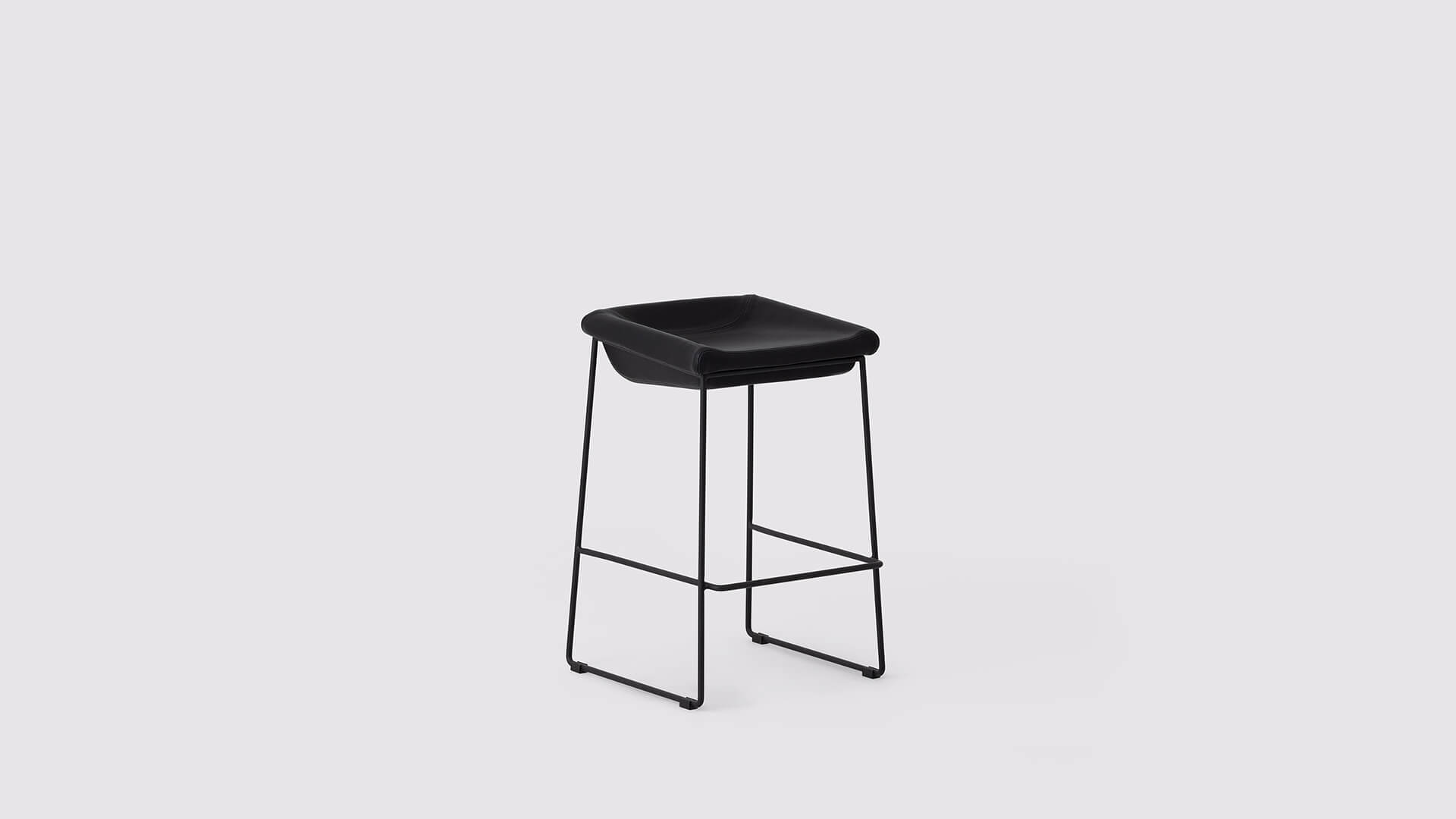 Angled view of the Mackenzie Custom counter or bar stool with black seat and black base