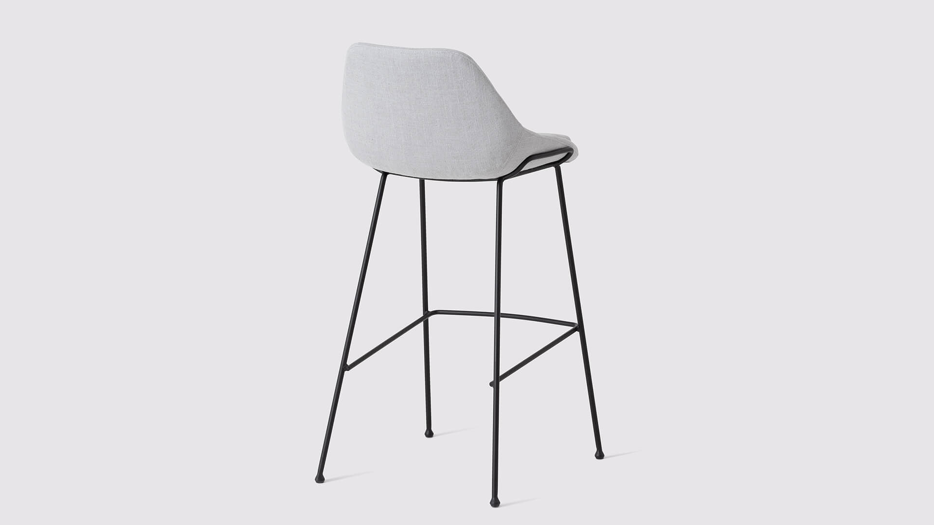 Back angled view of the Nixon custom bar stool in pale gray fabric