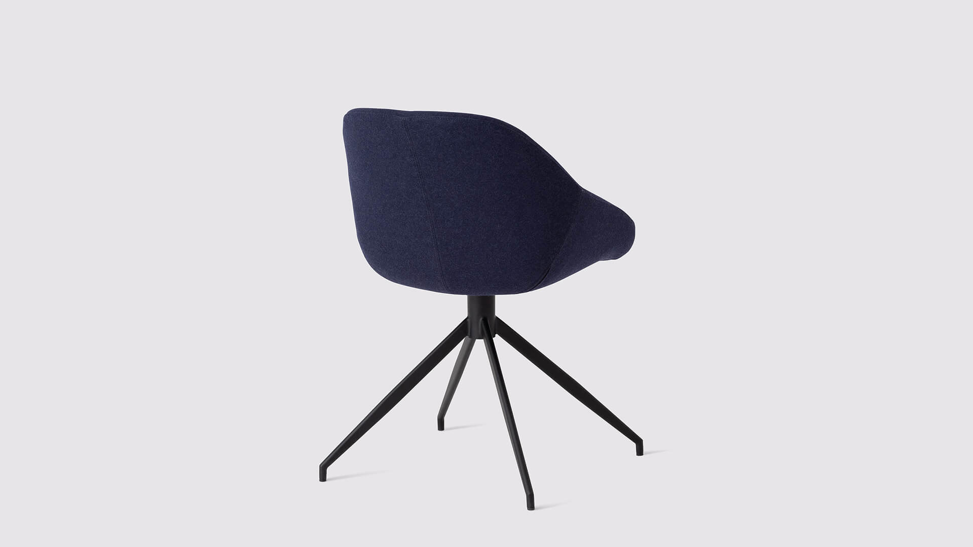 Back angled view of the Nixon custom modern dining chair in deep blue fabric