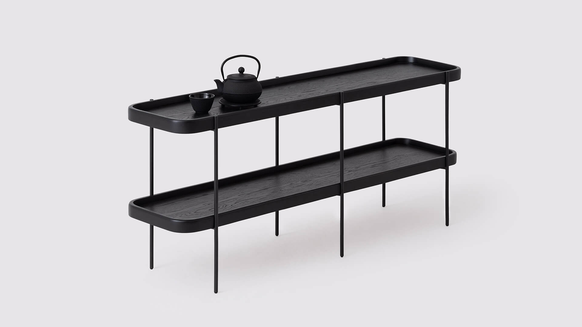 Angled view of the Sage modern console table in black oak with a tea set on it
