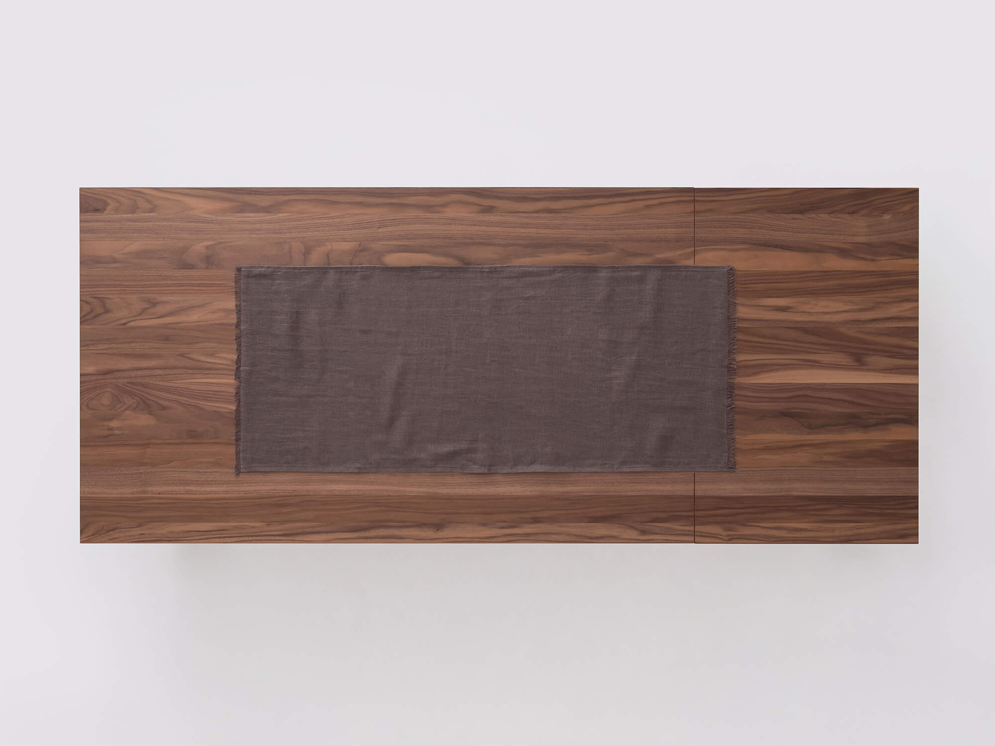 Overhead view of the Faye grey table runner on a table