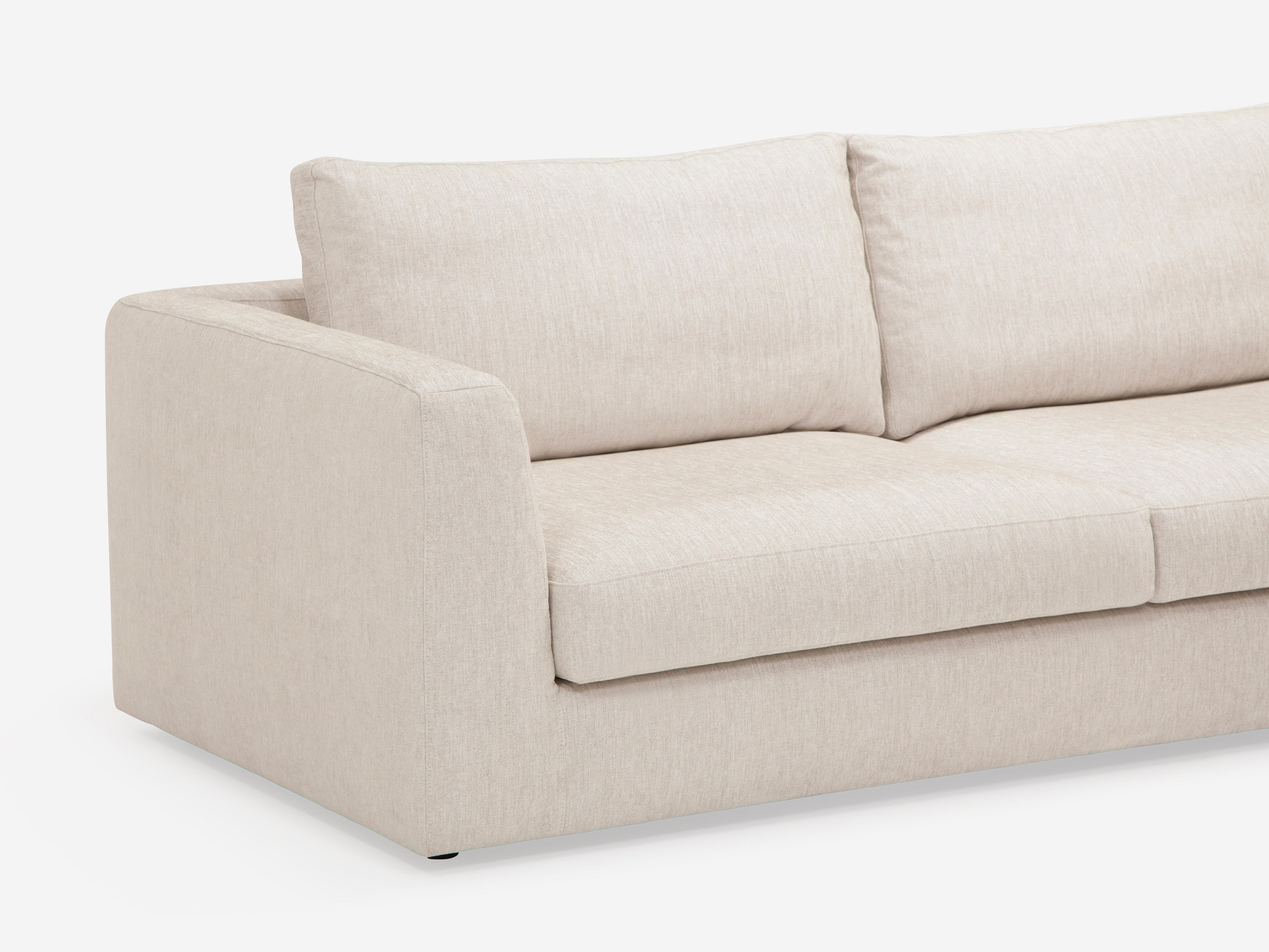 Detail view of the modern right hand facing sectional couch in white fabric chaise