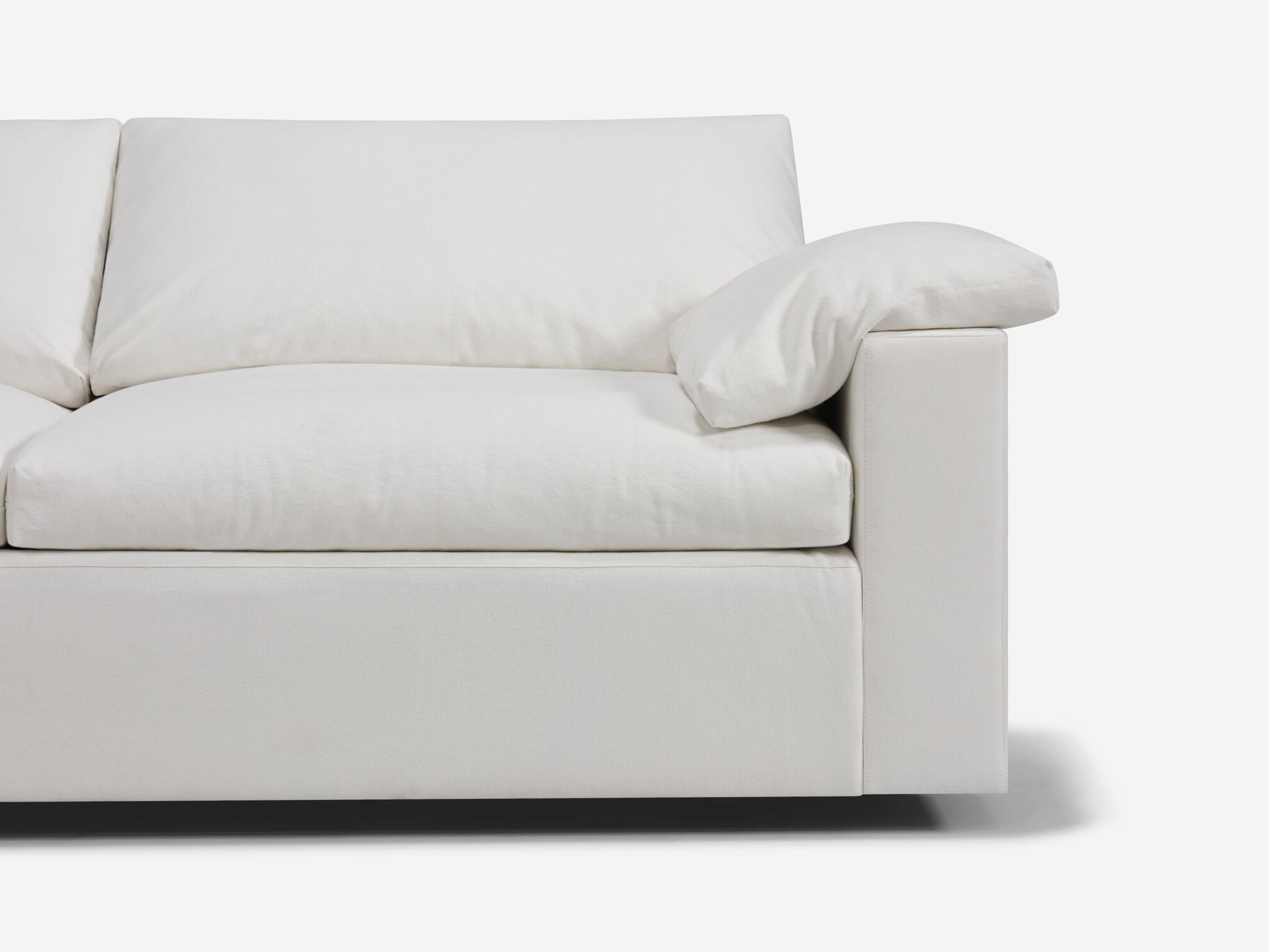 White sectional sofa with left hand chaise and pillow detail view