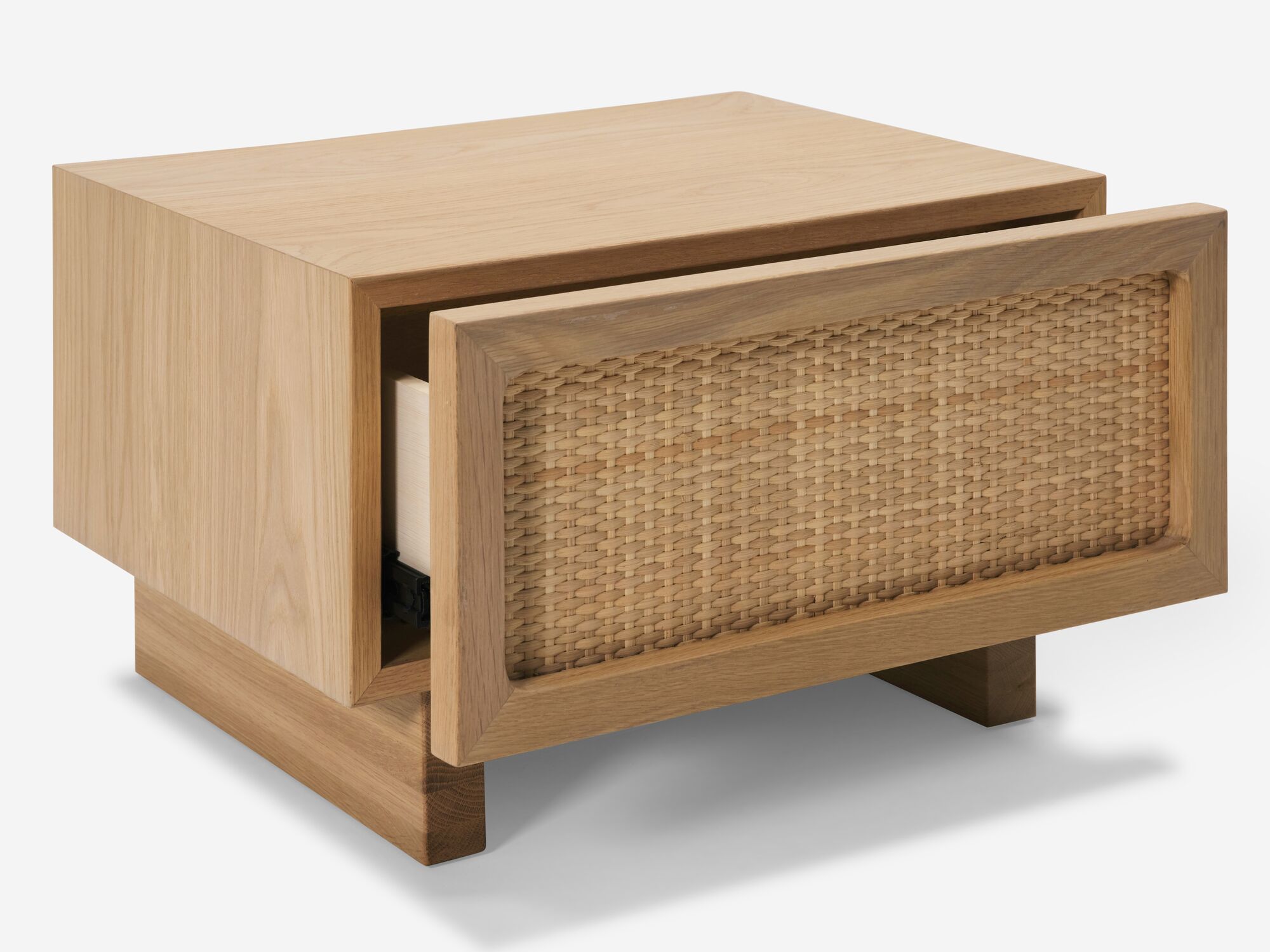 Open detail view of oak nightstand with woven drawer fronts drawer