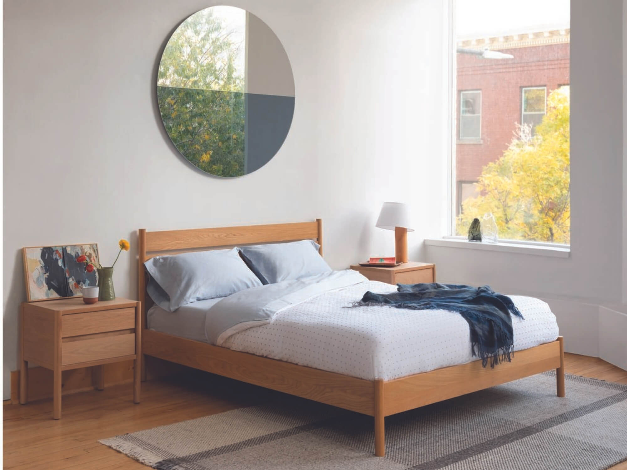 Oak platform bed with matching side tables in bedroom