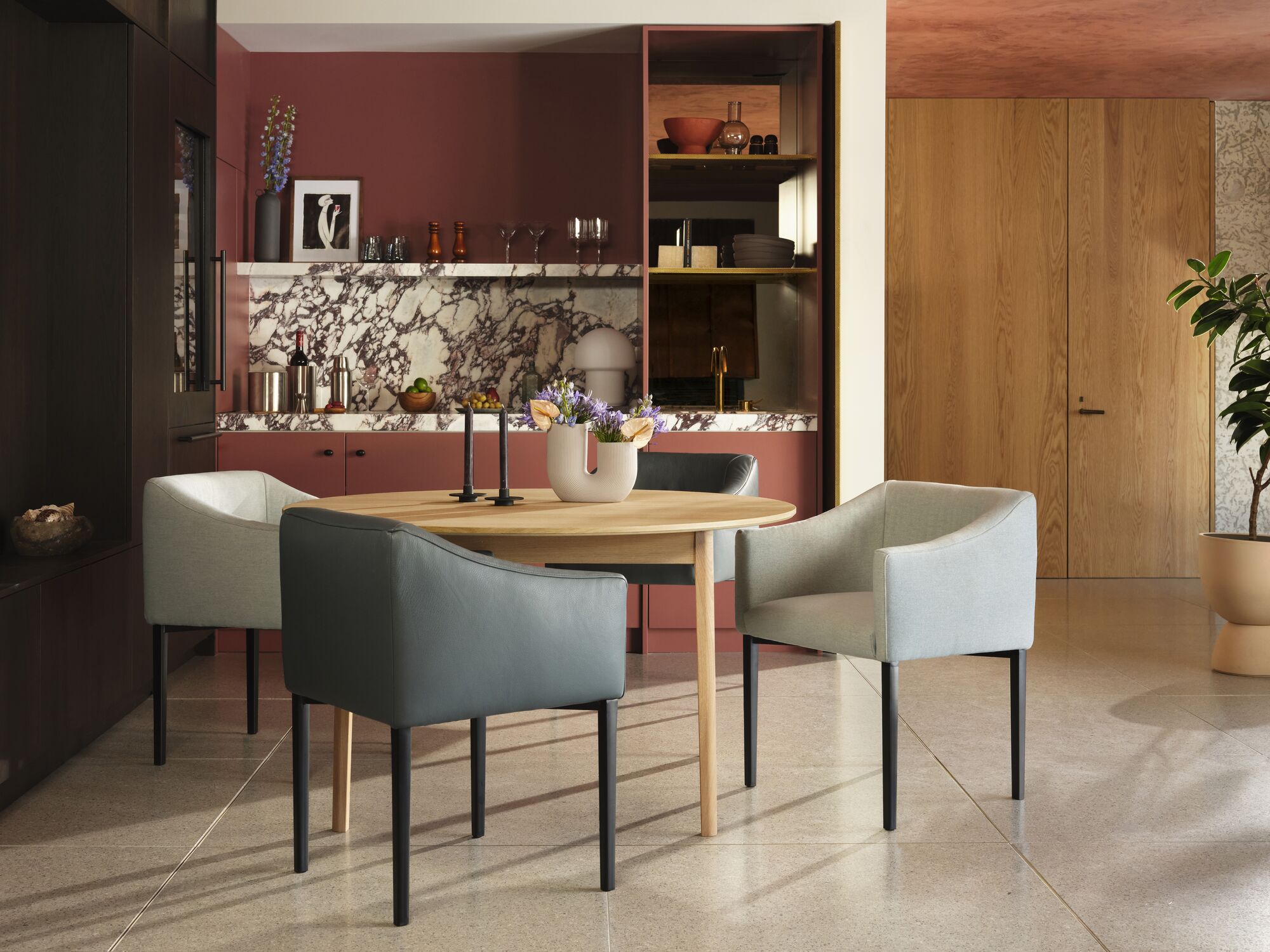 Ivory fabric and grey leather dining chairs around an oak dinette table