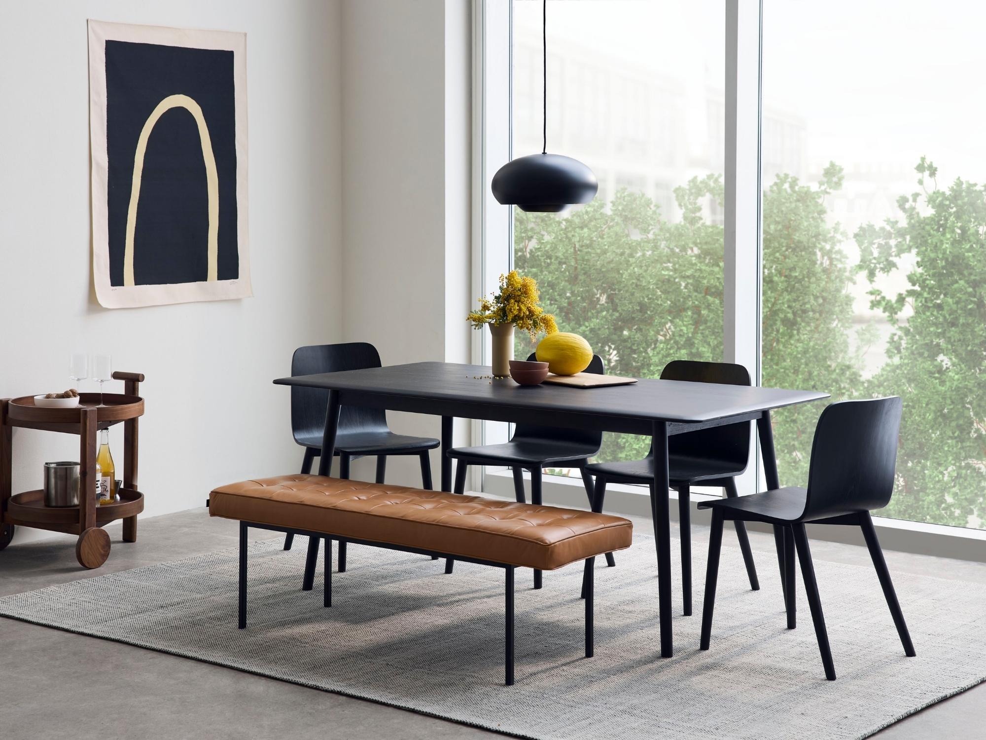 Gray rug in modern dining room with black table and chairs
