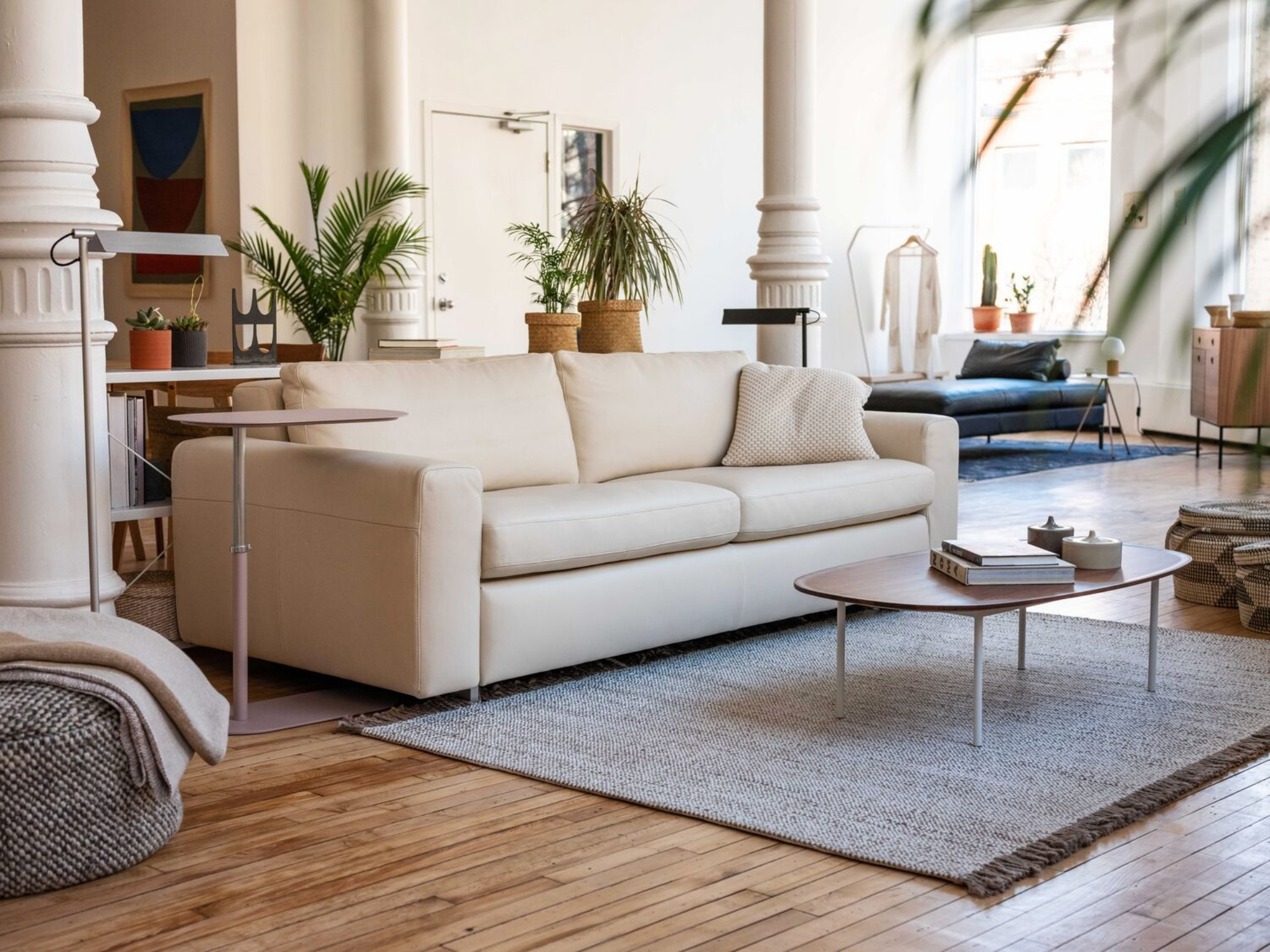 Grey tasseled area rug in a modern loft living room