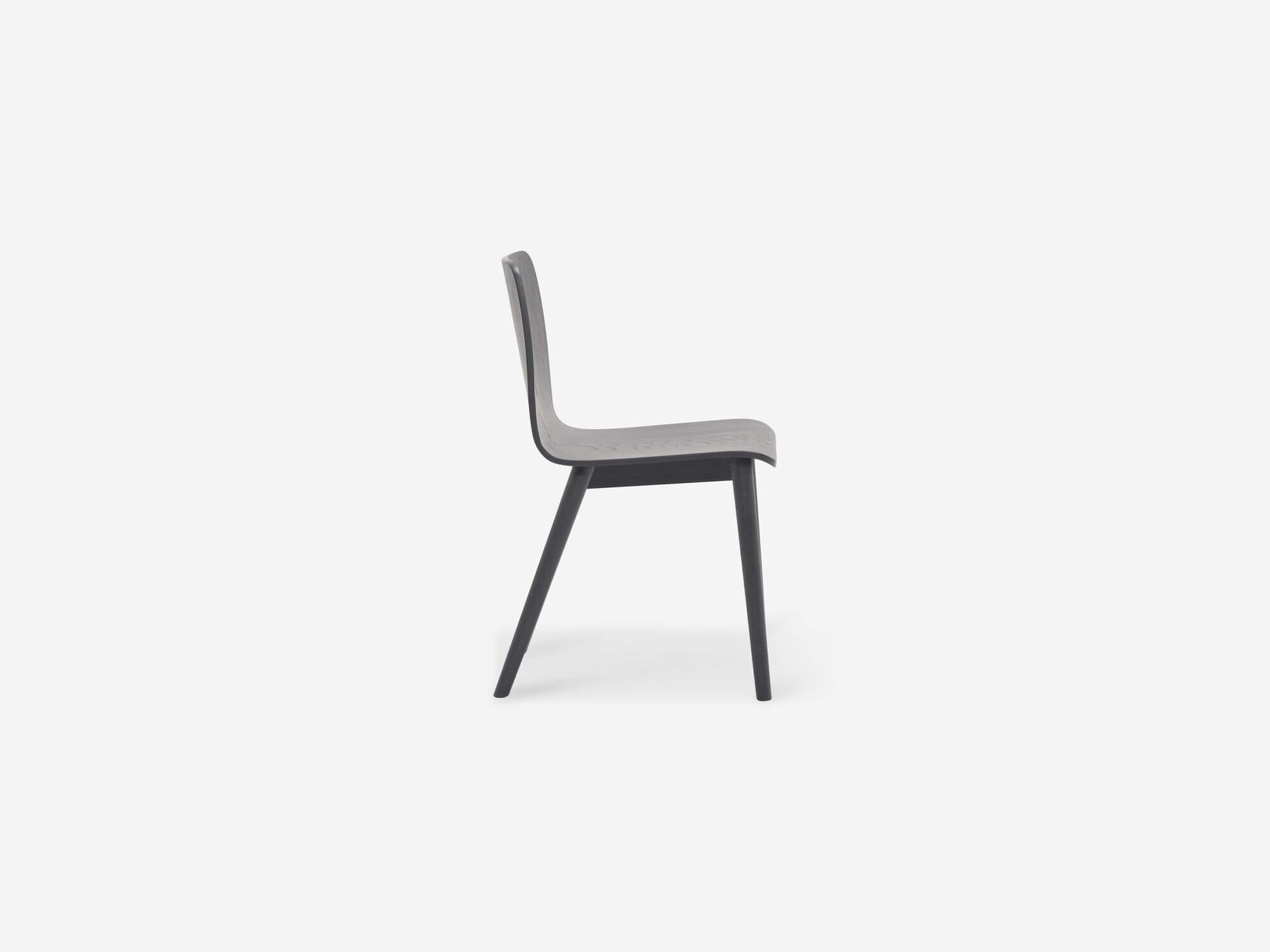 Side view of the Tami mid century dining chair in black oak