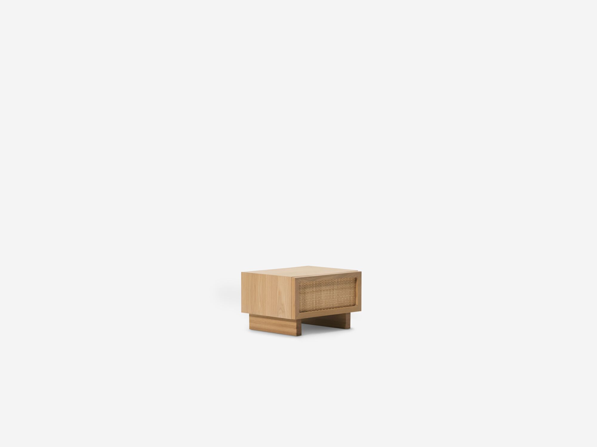 Front angle view of oak nightstand with woven drawer fronts
