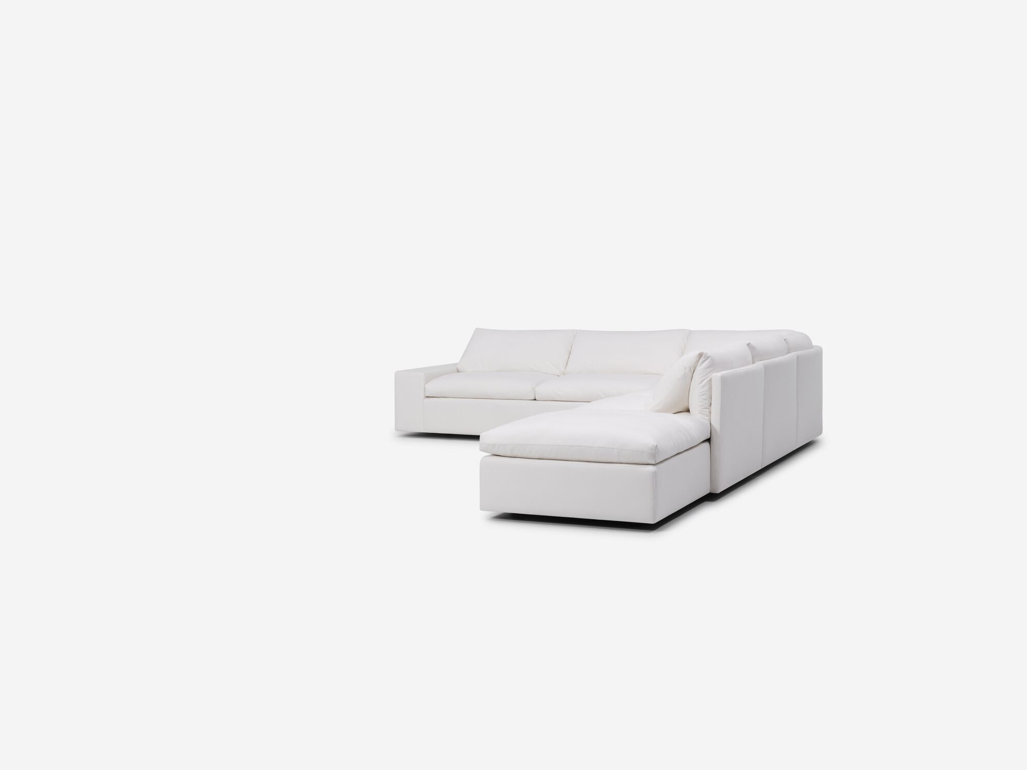 Right angle view of white sectional sofa with right hand chaise and wide arms
