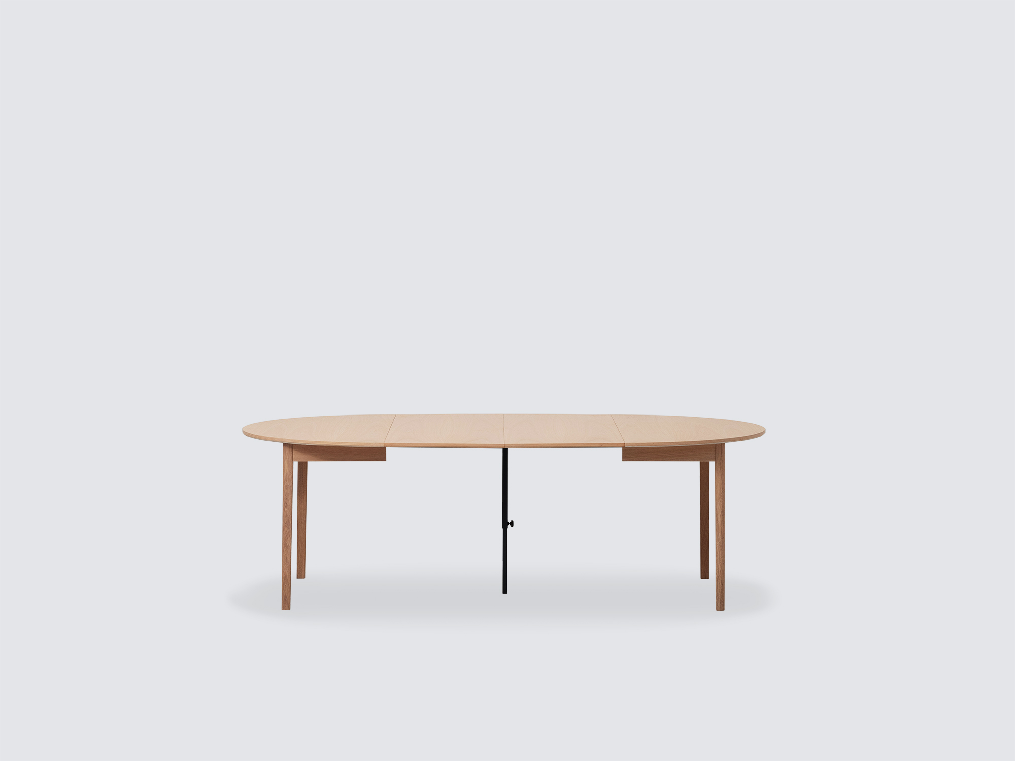 Side view of the small expanded Ease Expandable Dining Table in oak