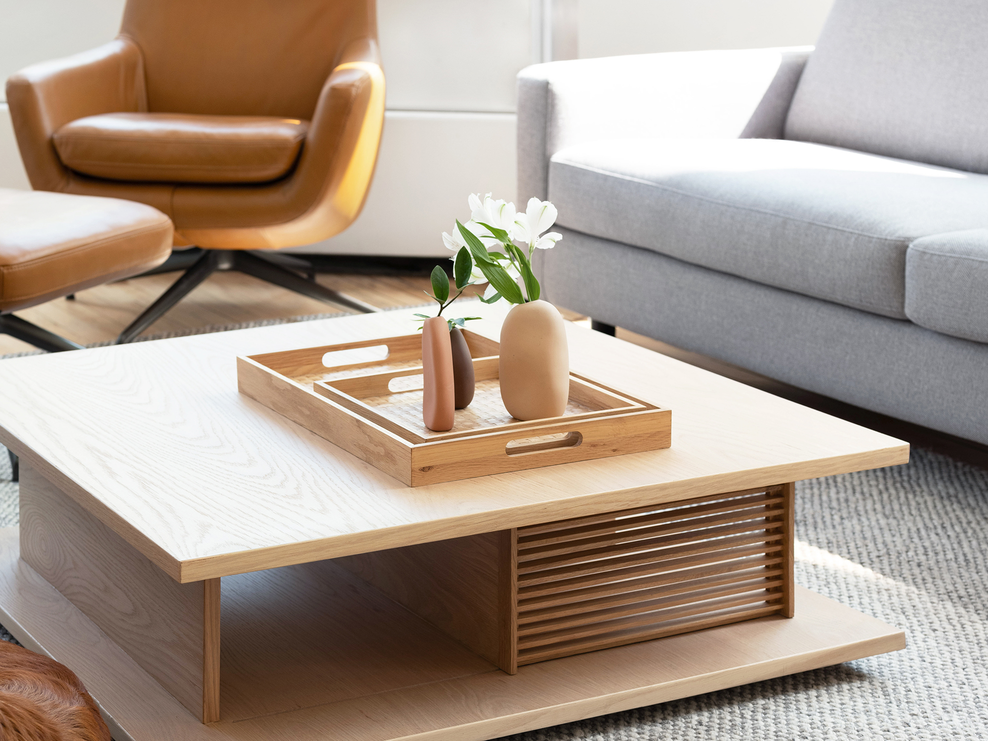 Assorted ceramic vases in earthy tones and organic shapes on top of modern coffee table 