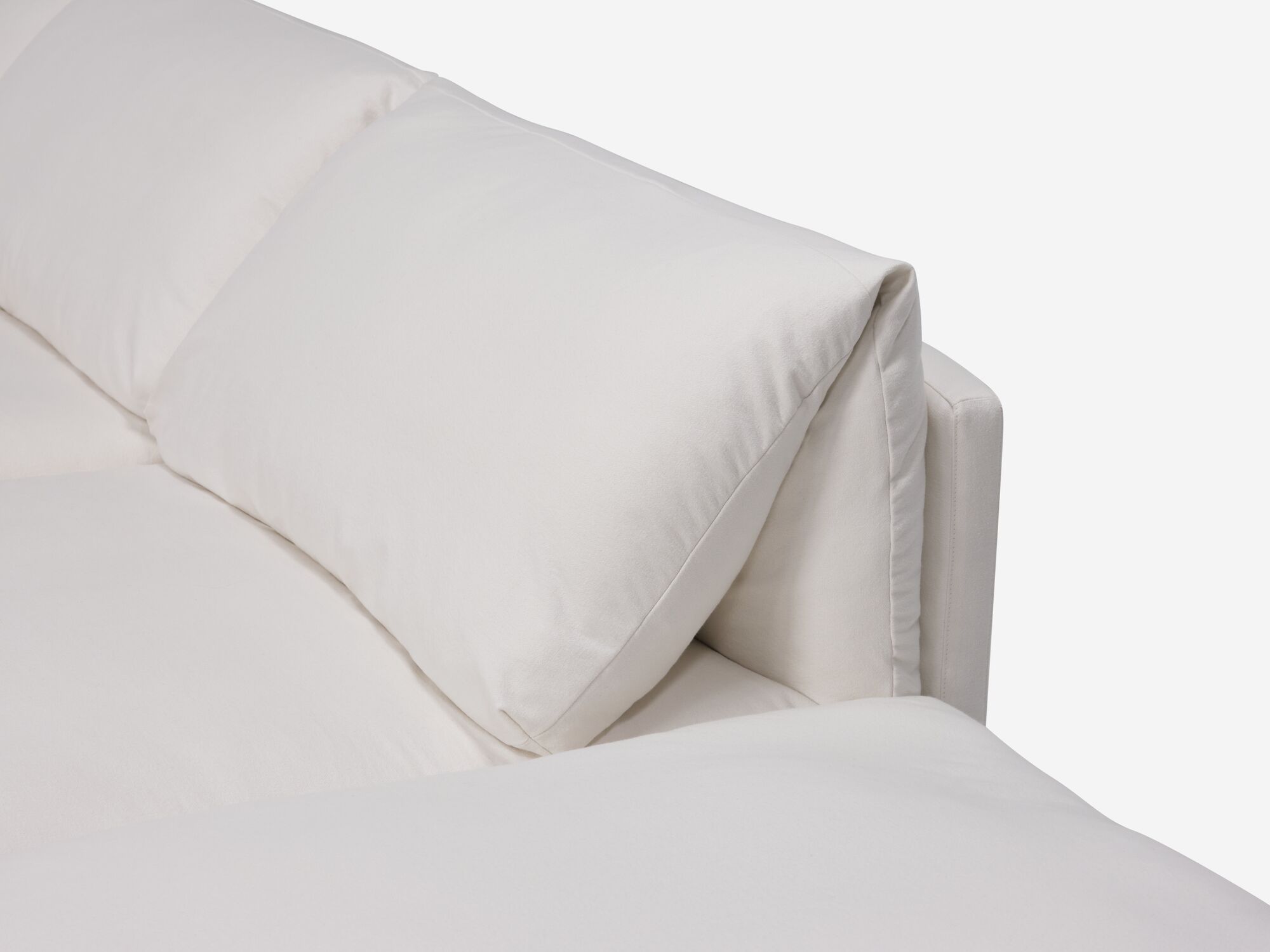 Detail pillow view of white sectional sofa with narrow arms and right hand chaise